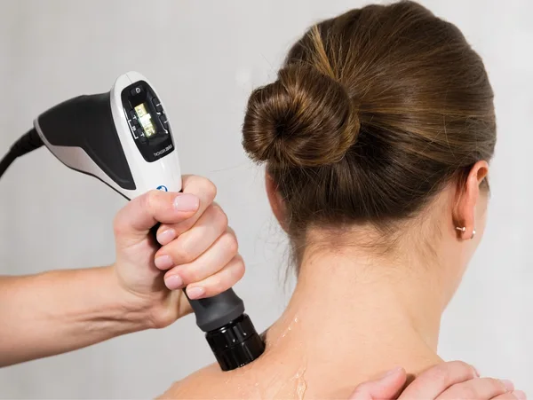 Device applied to woman's neck therapy.